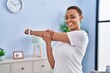 © Krakenimages.com - African american woman smiling confident stretching arm at home