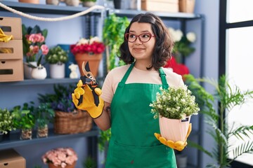 Canvas Print - Young hispanic woman working at florist shop smiling looking to the side and staring away thinking.