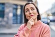 © Krakenimages.com - Middle age woman standing with doubt expression at street