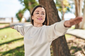 Sticker - Middle age woman smiling confident training yoga at park