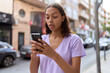 © Krakenimages.com - Young african american woman using smartphone with serious expression at street