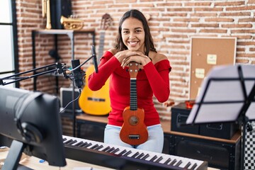 Canvas Print - Young african american woman musician smiling confident holding ukelele at music studio