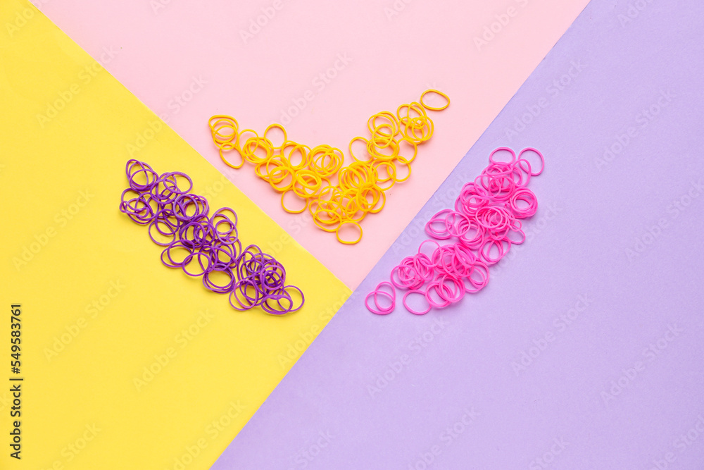 Office colorful rubber bands on color background