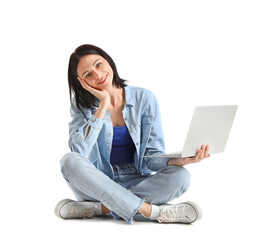 Pretty young woman with laptop sitting against white background