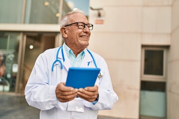 Sticker - Senior man wearing doctor uniform using touchpad at street