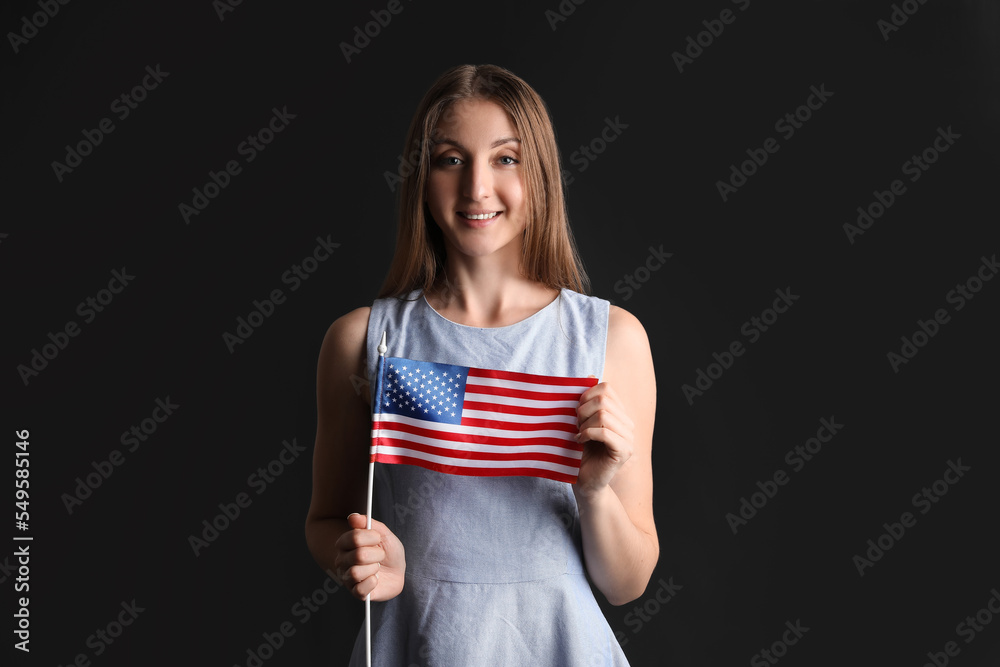 Beautiful woman with USA flag on black background