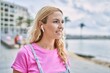 © Krakenimages.com - Young blonde woman smiling confident using earphones at seaside