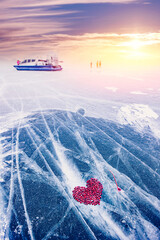 Wall Mural - Cocktail kiss winter of lake Baikal with straw and hole in pure ice with cranberry heart sunset sky