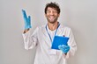 © Krakenimages.com - Hispanic scientist man working with tablet celebrating victory with happy smile and winner expression with raised hands
