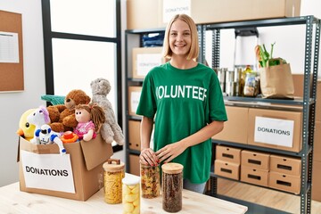 Sticker - Young caucasian woman wearing volunteer t shirt at donations stand with a happy and cool smile on face. lucky person.