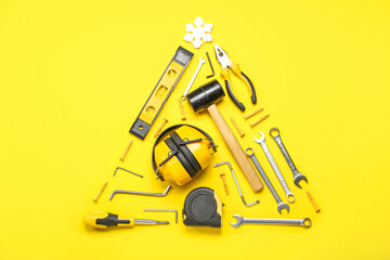 Sticker - Christmas tree made of builder's tools and snowflake on yellow background