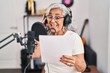 © Krakenimages.com - Middle age woman musician singing song at music studio