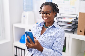 Canvas Print - Middle age african american woman business worker using smartphone working at office