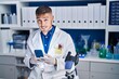 © Krakenimages.com - Young hispanic man scientist using smartphone at laboratory