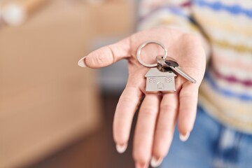 Sticker - Young caucasian woman holding key at new home