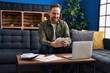 © Krakenimages.com - Young caucasian man using laptop counting dollars at home