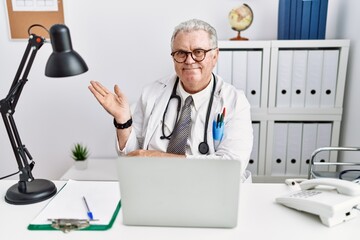 Sticker - Senior caucasian man wearing doctor uniform and stethoscope at the clinic inviting to enter smiling natural with open hand