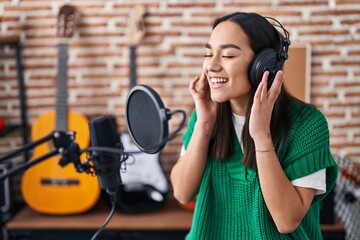 Sticker - Young hispanic woman musician singing song at music studio