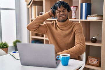 Sticker - Young african man with dreadlocks working using computer laptop confuse and wonder about question. uncertain with doubt, thinking with hand on head. pensive concept.