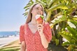 © Krakenimages.com - Young chinese girl smiling happy eating ice cream standing at the promenade.