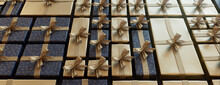 Contemporary Gold And Navy Blue Christmas Background. Precisely Arranged Festive Presents Form A Grid Pattern. 