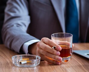 Poster - Male employee drinking alcohol and smoking cigarettes at workpla