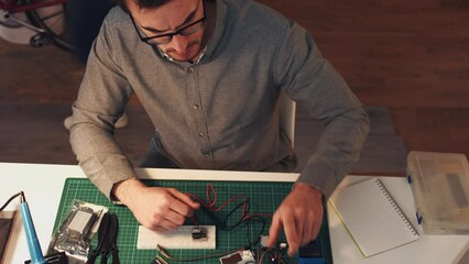 Canvas Print - IT, engineer and man working on computer, motherboard and circuit analysis in home office late at night. Design, circuit board and desktop expert looking at wires, model and problem solving in home