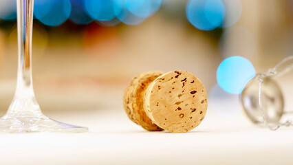 a glass of champagne and a cork on a festive New Year's table