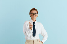 Positive Woman Showing Money Gesture. Portrait Of Business Girl Smiling And Showing Give Me Money Gesture, Asking For Payment. Indoor Studio Shot Isolated On Blue Background 