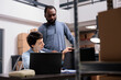 © DC Studio - Storehouse delivery team looking at metallic box checking package order while working at packaging production in warehouse. Multi ethnic workers analyzing shipment logistics on laptop computer