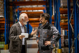 Fototapeta  - Warehouse manager and worker smiling and talking about work