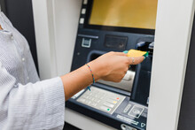 Hand Of Woman Inserting Credit Card In ATM Machine