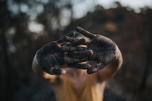 Woman Showing Hands Black With Ash Standing In Burnt Forest