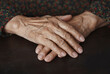 © Westend61 - Senior woman with wrinkled hands on table