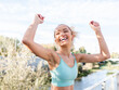 © Westend61 - Cheerful athlete enjoying with arms raised under sky
