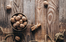 Bowl With Whole Walnuts On Wooden Background, Flat Lay.