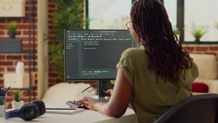 Young woman using source code to develop new online app, working with html script on terminal window to program database software. IT manager planning artificial intelligence network.