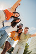 © Jose Calsina - Vertical portrait of a Group of smiling multiracial teenagers having fun outdoors. Cherful young people laughing together on vacation. Lifestyle concept. High quality photo
