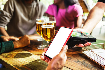 customer using mobile phone to pay the bill in a bar. young man hands holding smartphone with white 