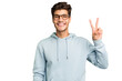 © Asier - Young caucasian handsome man isolated joyful and carefree showing a peace symbol with fingers.