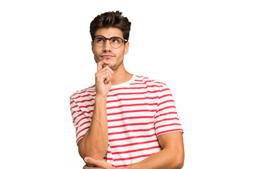 Wall Mural - Young caucasian handsome man isolated looking sideways with doubtful and skeptical expression.