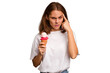 © Asier - Young caucasian woman holding an ice cream isolated pointing temple with finger, thinking, focused on a task.