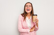 © Asier - Business caucasian woman holding a take away coffee isolated on white background laughing and having fun.