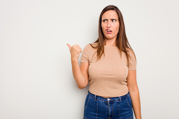 Wall Mural - Young caucasian cute woman isolated on white background shocked pointing with index fingers to a copy space.