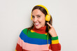 © Asier - Young caucasian woman listening to music with headphones isolated on white background