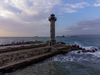 Wall Mural - flying around the lighthouse on a drone early in the morning at sunrise