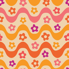 Retro 70s hippie flowers on groovy waves seamless pattern in pink, yellow and orange. For fabric, textile and wrapping paper 