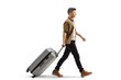 © Ljupco Smokovski - Full length profile shot of a guy walking and pulling a suitcase