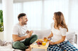 © Dusan Petkovic - A happy couple is sitting in a bed and having breakfast.