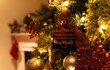 Beautiful closeup of a house miniature toy hanged on a decorated Christmas tree